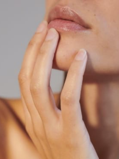 Close-up of a person touching their chin thoughtfully.