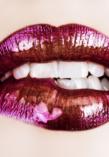 macro of beautiful lips with purple and gold lipstick